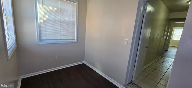 a small space with wooden floor and a window