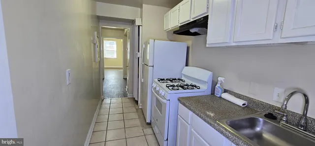 a kitchen with granite countertop a stove and a sink