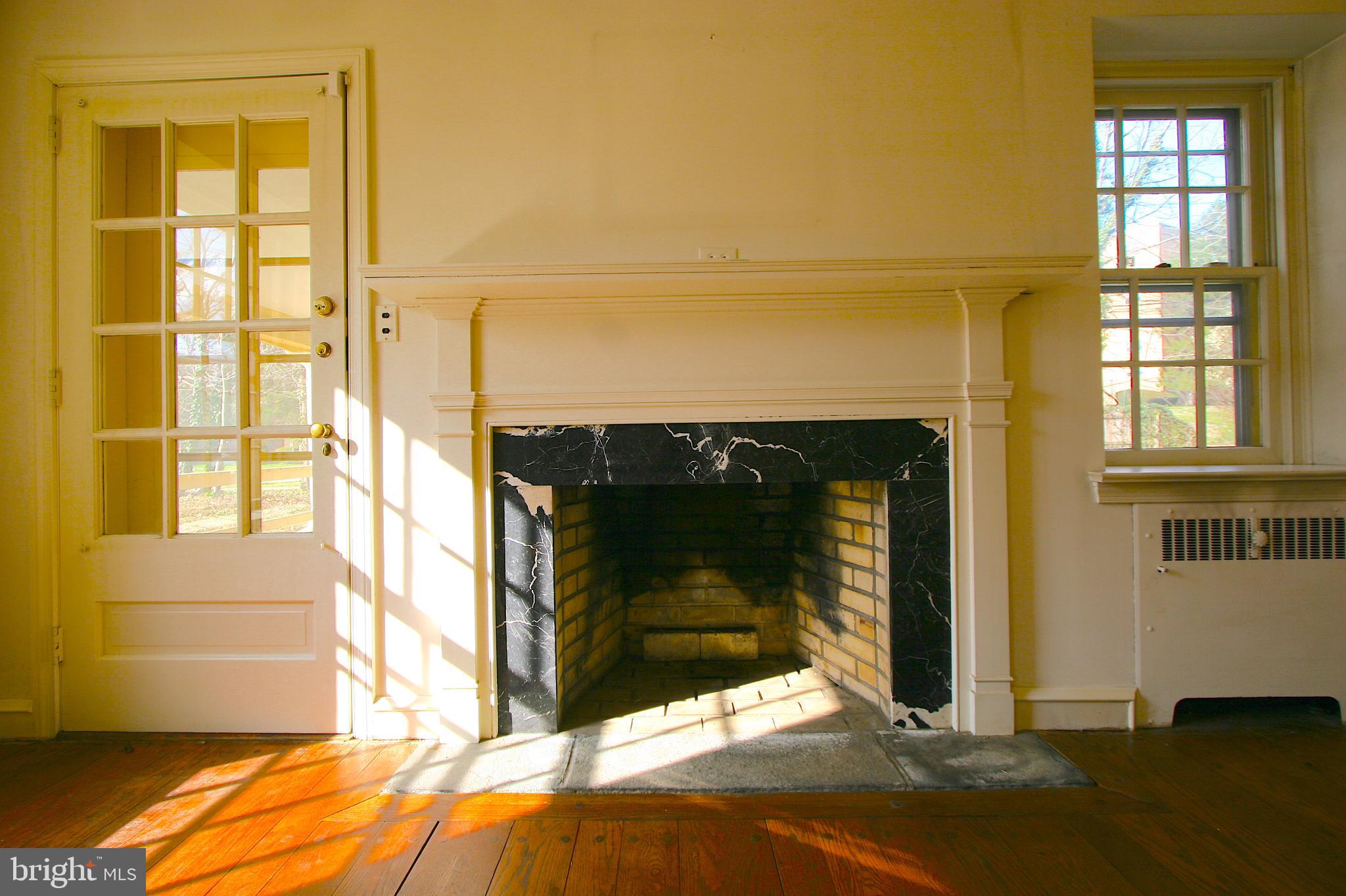 1200 Knox Road Wynnewood, PA 19096 - Photo 9 of 32 Living Room Fireplace, doorway to exterior porch