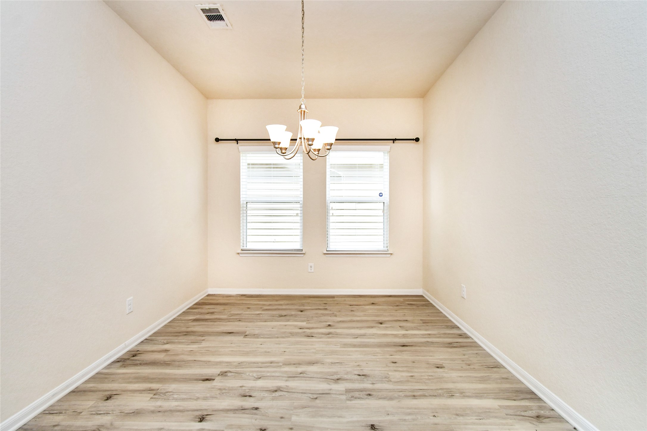 3227 Thicket Path Way Katy, TX 77493 - Photo 12 of 40 en empty room with wooden floor and window