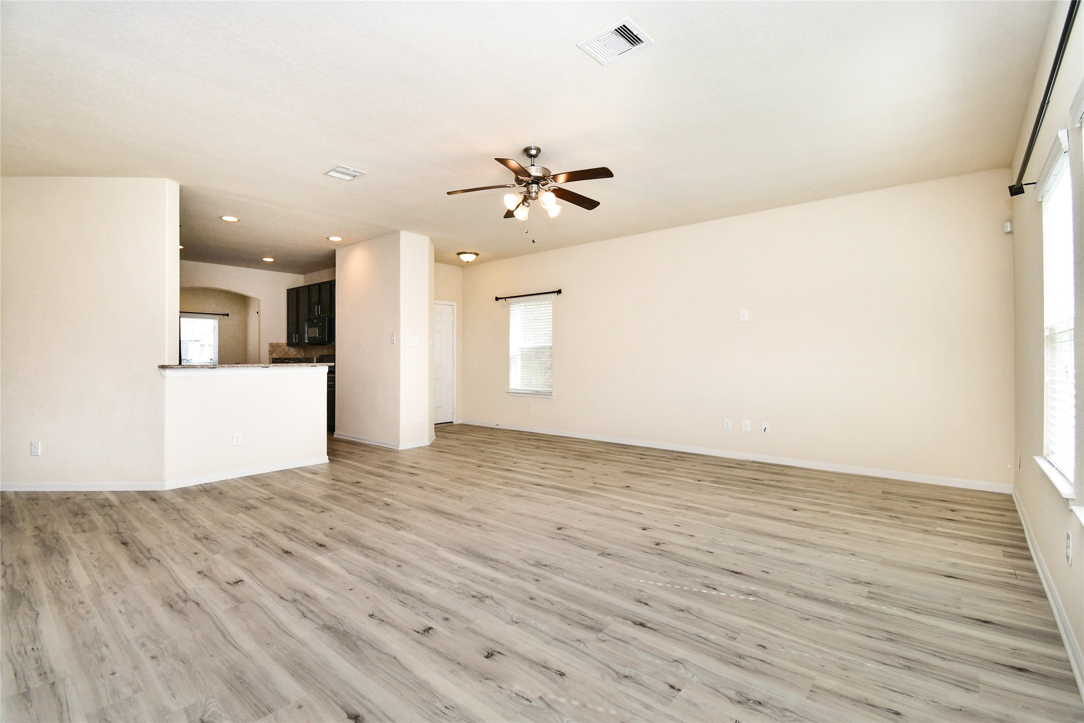 3227 Thicket Path Way Katy, TX 77493 - Photo 13 of 40 wooden floor in an empty room with a window