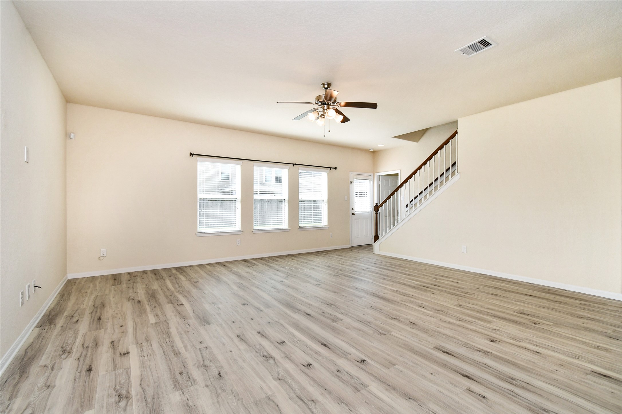 3227 Thicket Path Way Katy, TX 77493 - Photo 15 of 40 a view of an empty room with wooden floor and a window