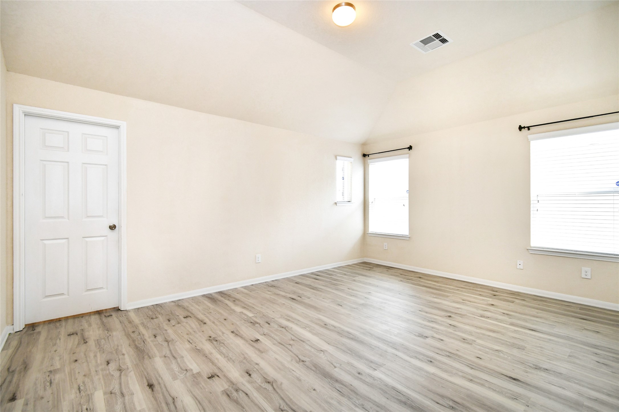 3227 Thicket Path Way Katy, TX 77493 - Photo 19 of 40 an empty room with wooden floor and windows
