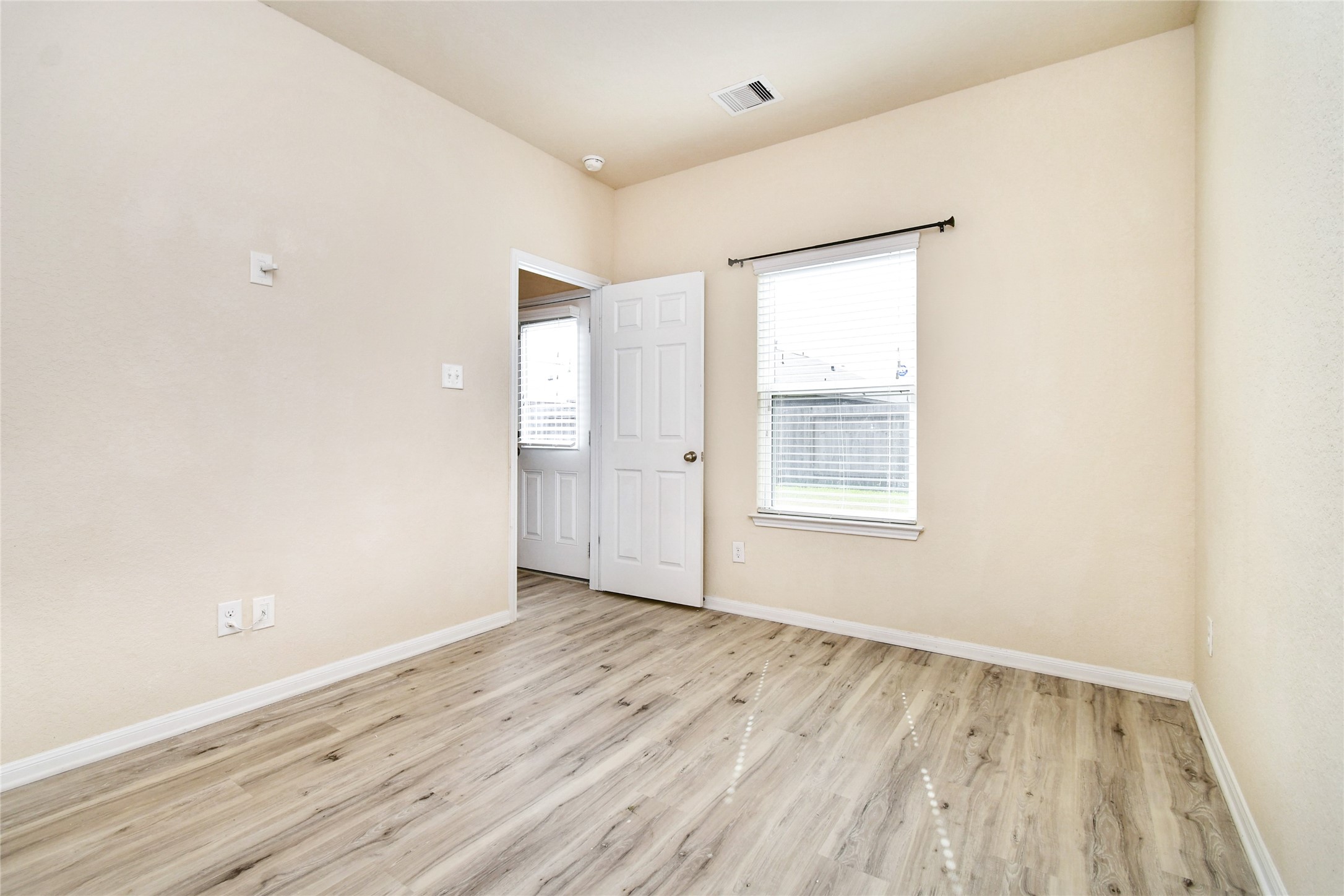 3227 Thicket Path Way Katy, TX 77493 - Photo 24 of 40 an empty room with wooden floor and windows