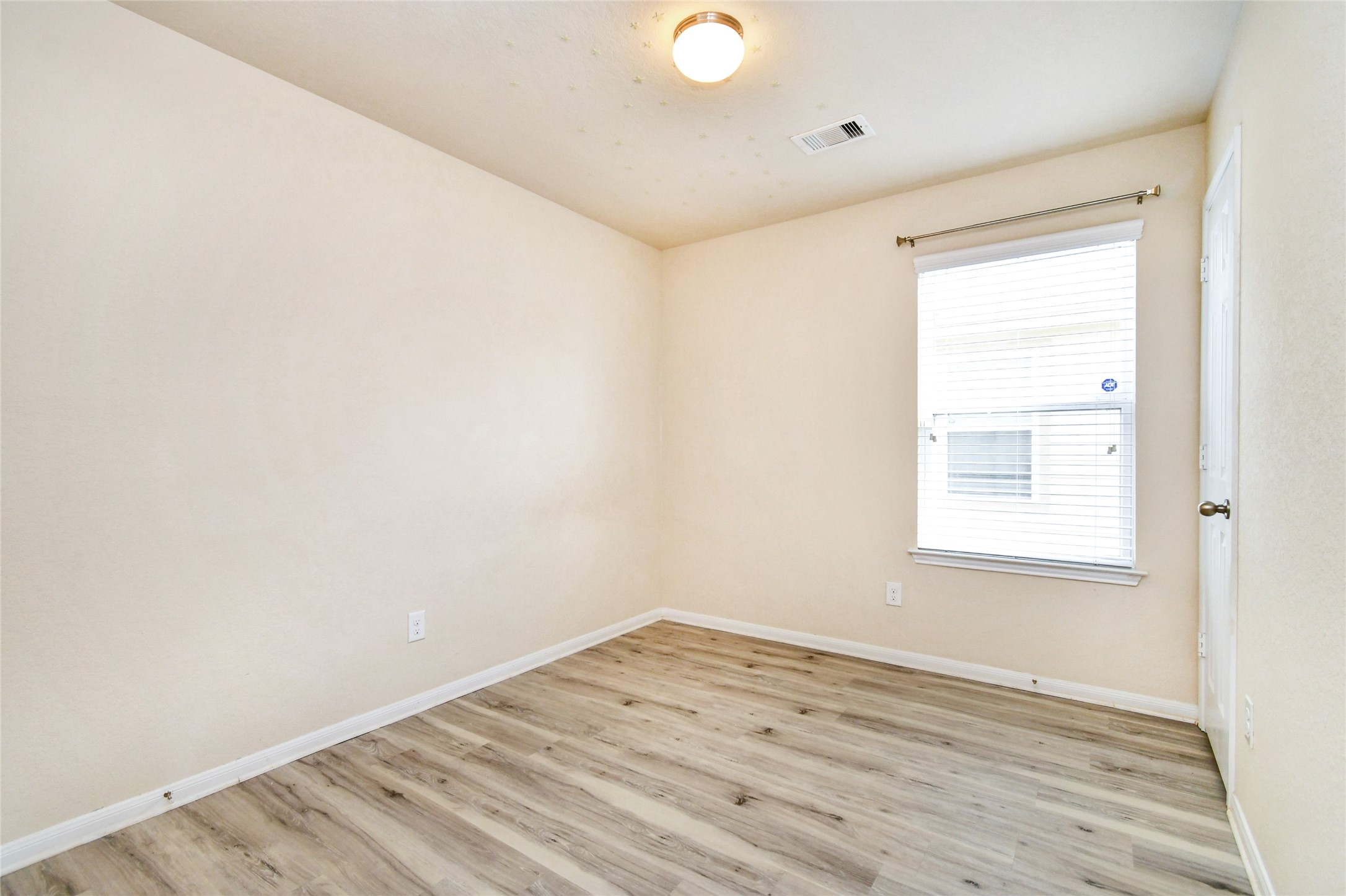 3227 Thicket Path Way Katy, TX 77493 - Photo 26 of 40 an empty room with wooden floor and windows