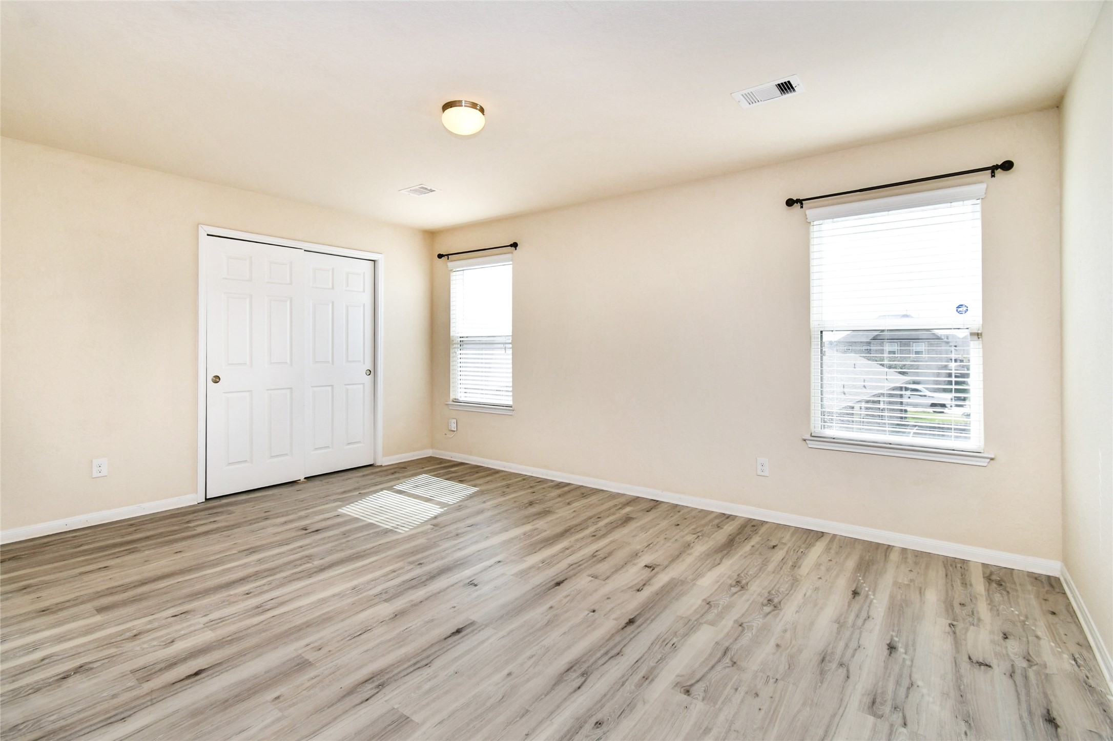 3227 Thicket Path Way Katy, TX 77493 - Photo 30 of 40 an empty room with wooden floor and windows