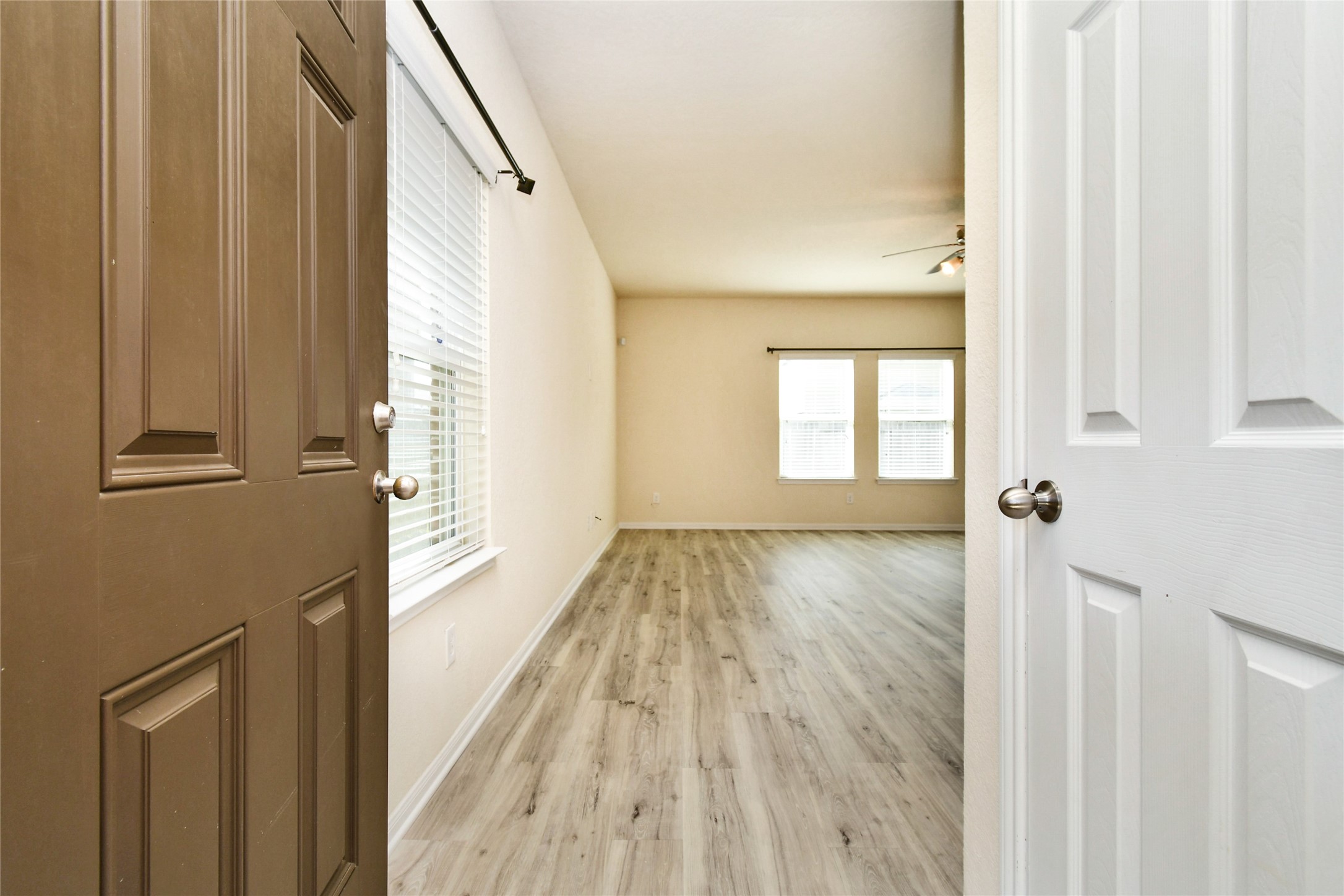 3227 Thicket Path Way Katy, TX 77493 - Photo 3 of 40 a view of an empty room with wooden floor and a window