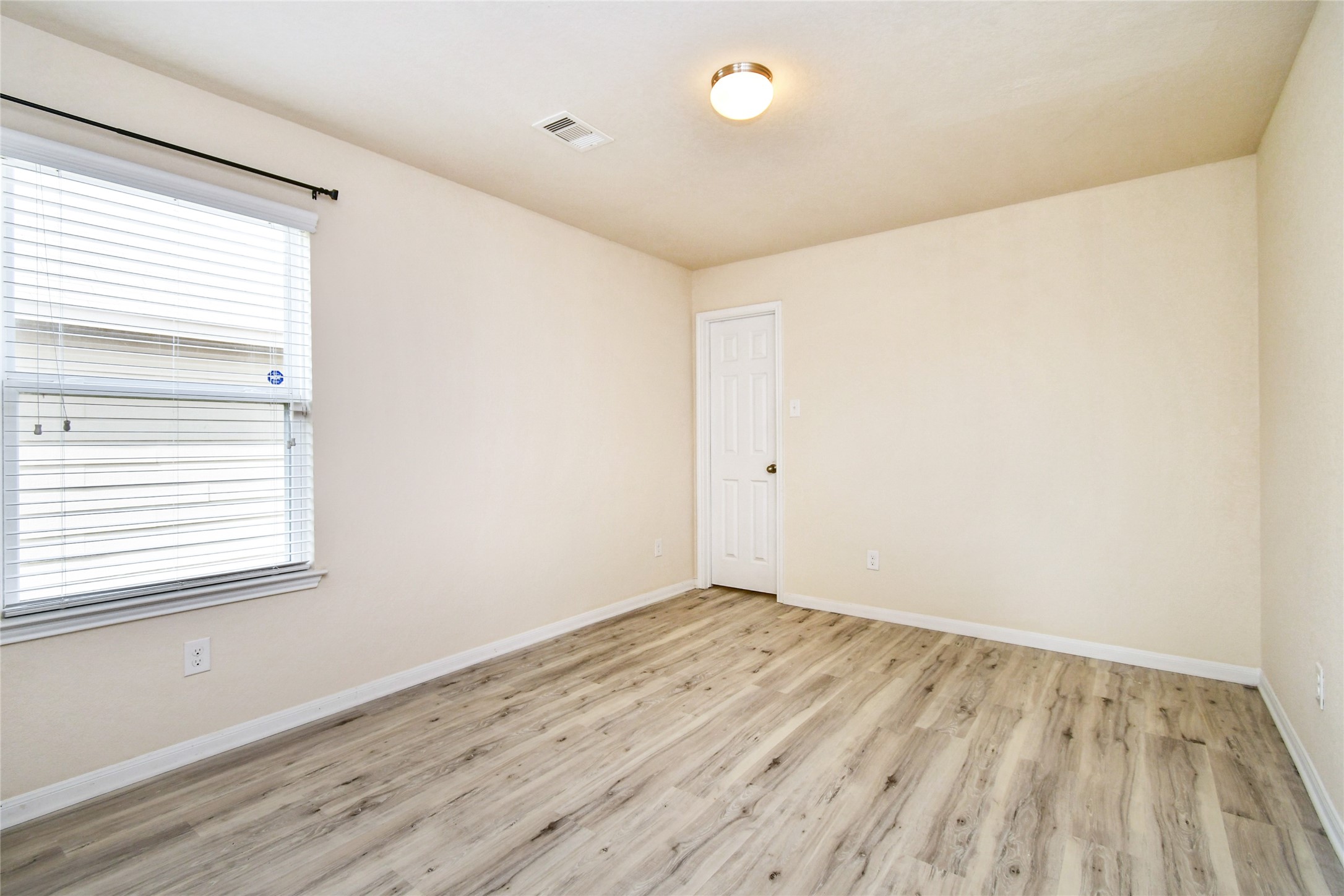 3227 Thicket Path Way Katy, TX 77493 - Photo 31 of 40 an empty room with wooden floor and windows