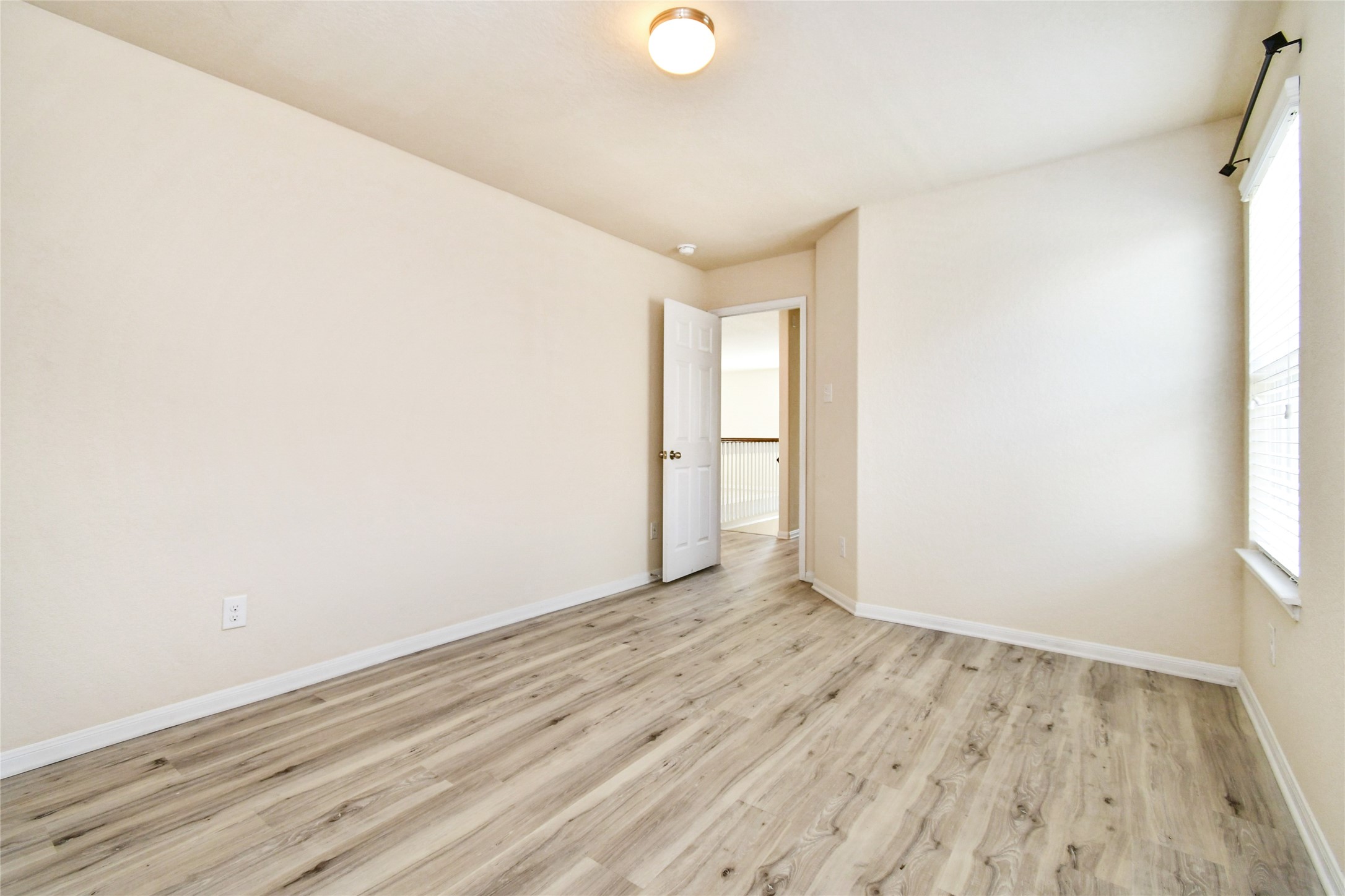 3227 Thicket Path Way Katy, TX 77493 - Photo 32 of 40 an empty room with wooden floor and windows