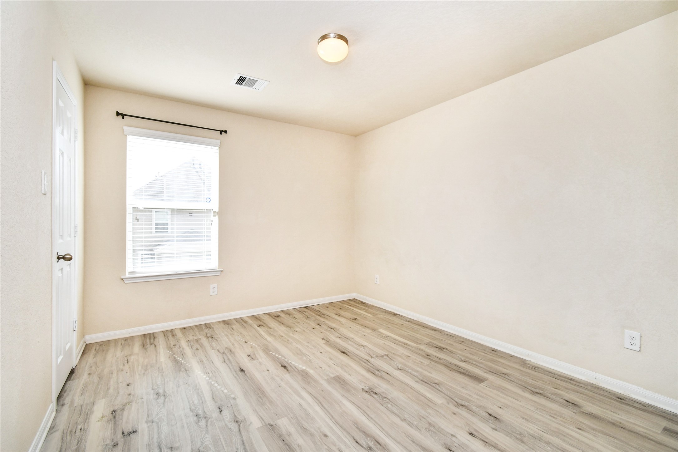 3227 Thicket Path Way Katy, TX 77493 - Photo 34 of 40 an empty room with wooden floor and windows