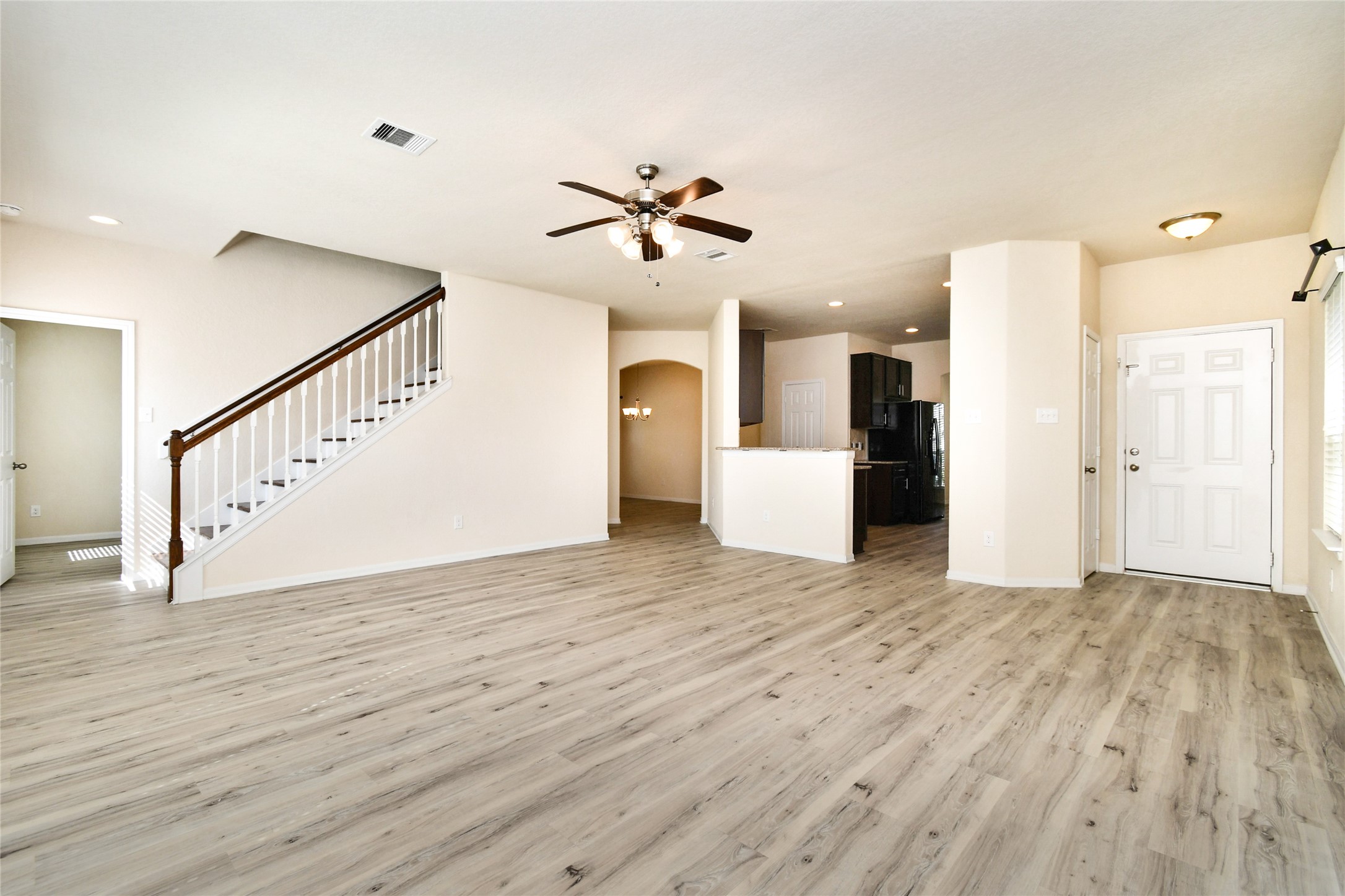 3227 Thicket Path Way Katy, TX 77493 - Photo 4 of 40 a view of a kitchen with wooden floor and a ceiling fan
