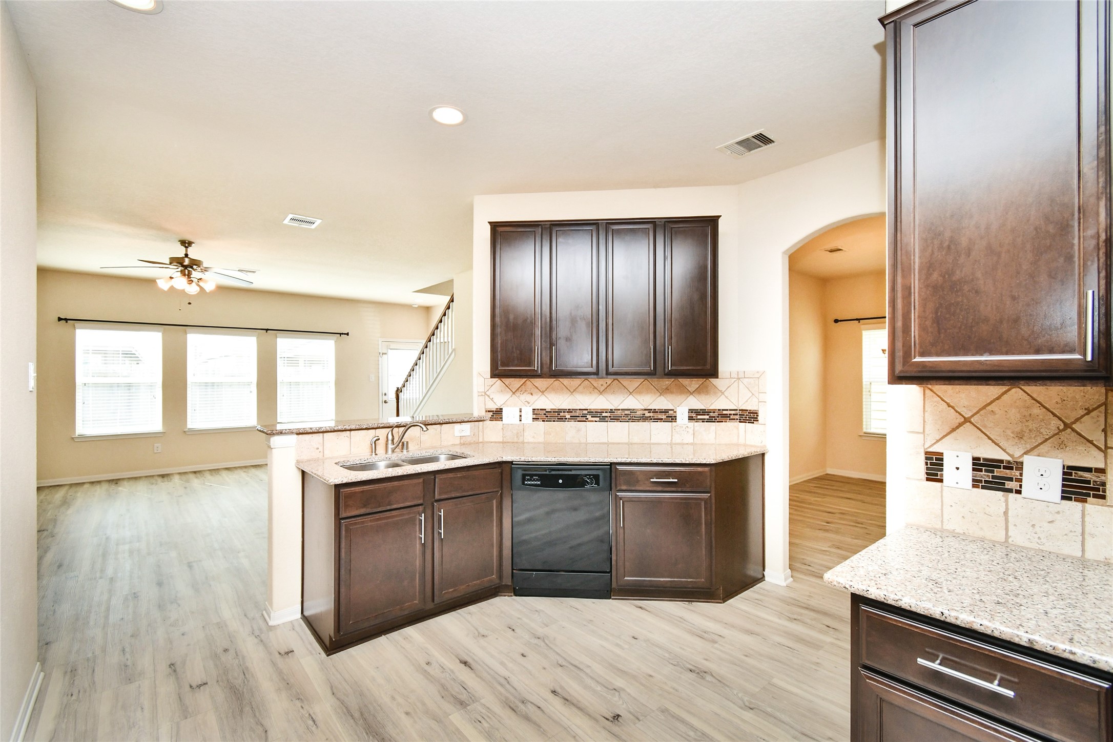 3227 Thicket Path Way Katy, TX 77493 - Photo 6 of 40 a kitchen with stainless steel appliances granite countertop a sink and wooden cabinets