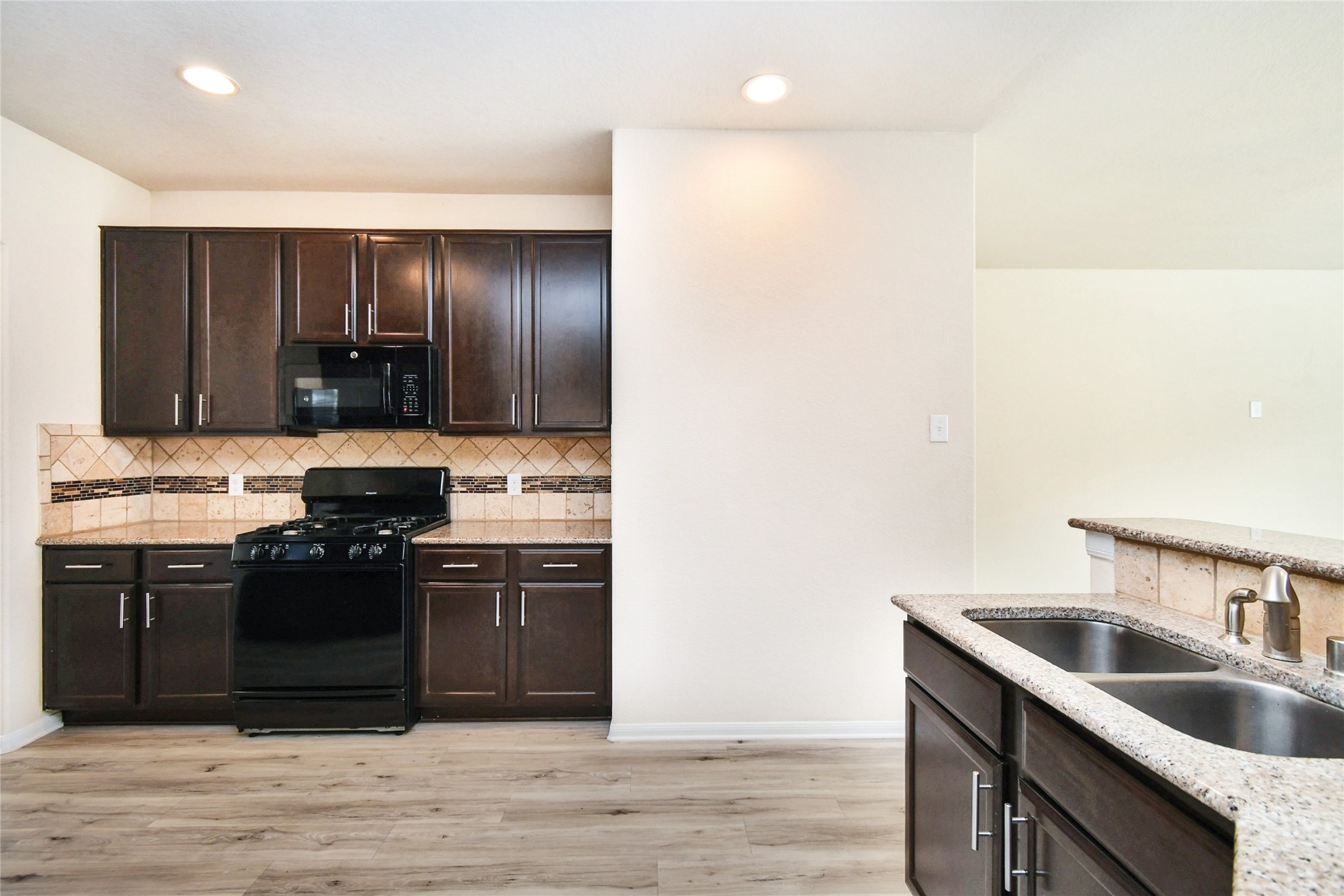 3227 Thicket Path Way Katy, TX 77493 - Photo 7 of 40 a kitchen with stainless steel appliances granite countertop a sink and stove top oven