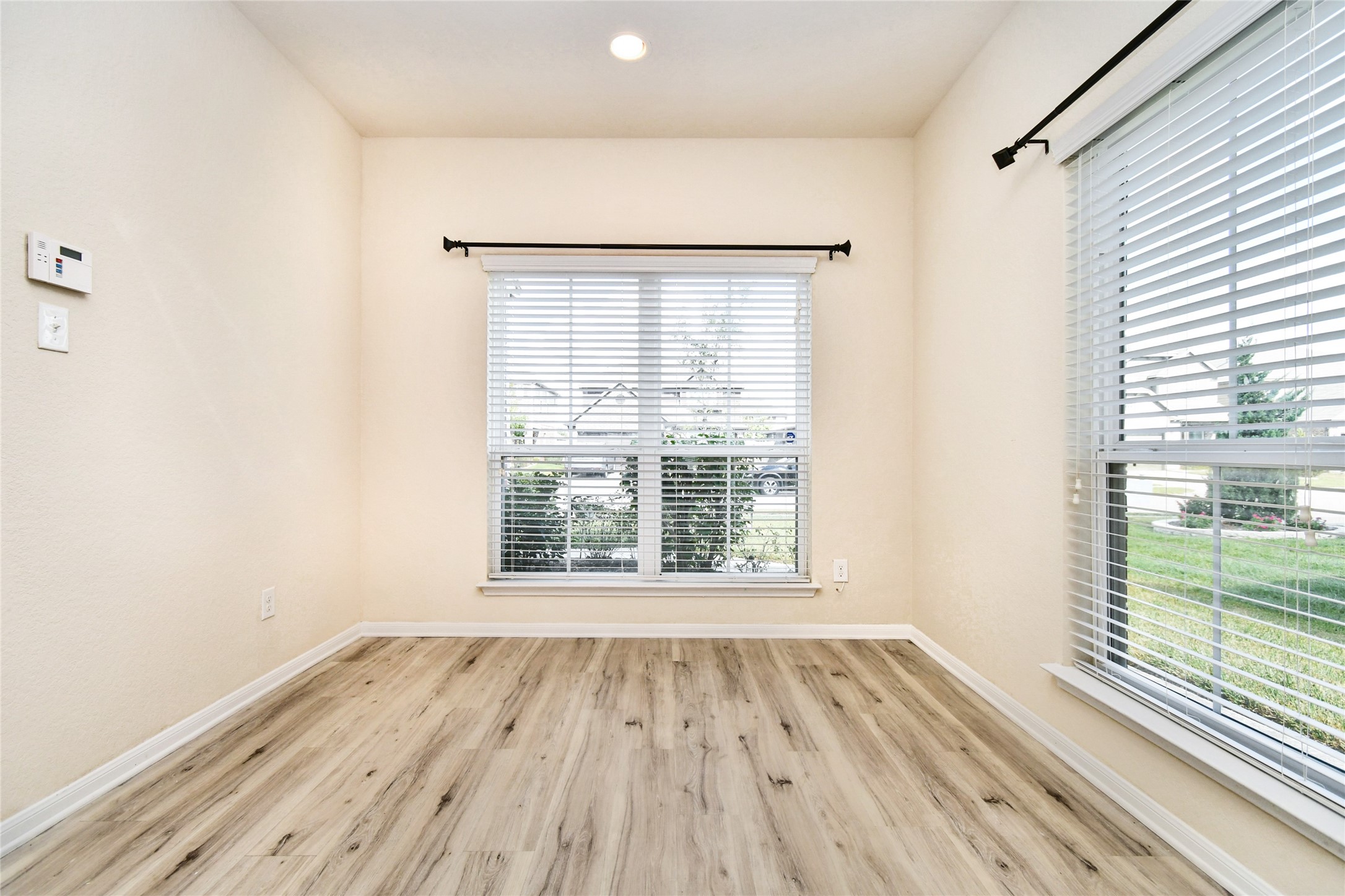 3227 Thicket Path Way Katy, TX 77493 - Photo 10 of 40 an empty room with wooden floor and windows