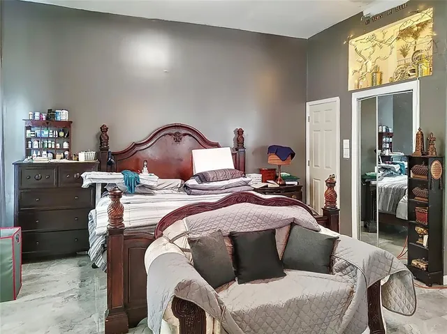 a bedroom with a bed and a chandelier