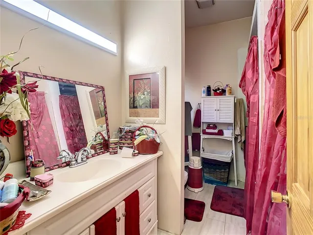 a bedroom with two beds and painting on the wall