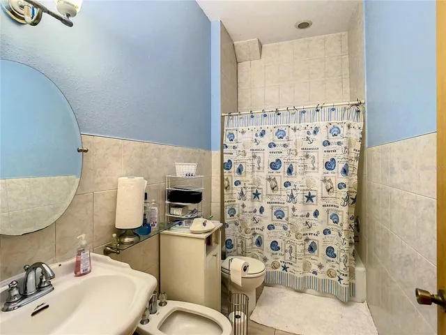 a kitchen with stainless steel appliances granite countertop a sink refrigerator and cabinets