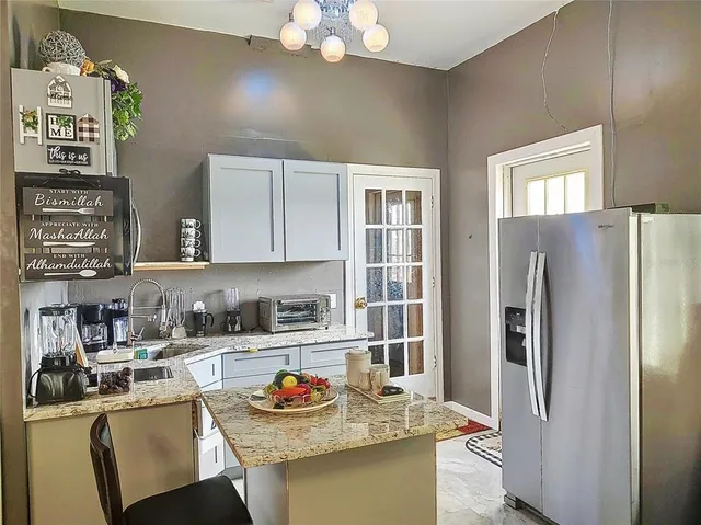 a view of house with garden and tall trees