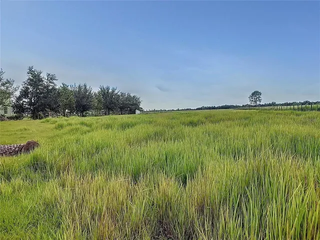an aerial view of multiple houses with yard