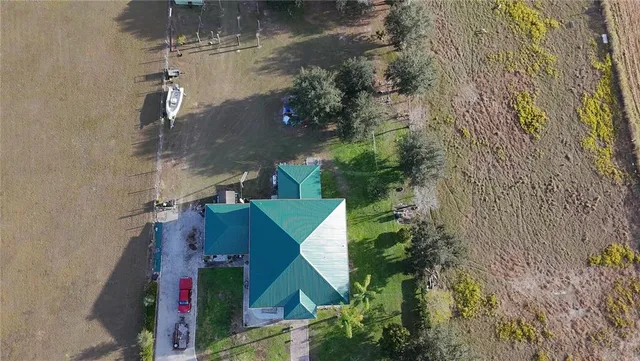 an aerial view of ocean with residential house and outdoor space
