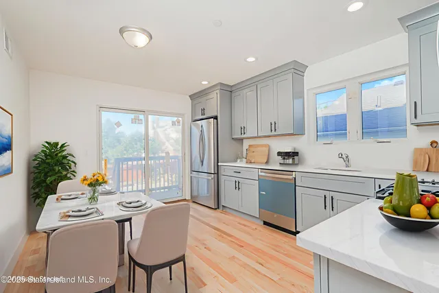 a kitchen with a table chairs stove and cabinets