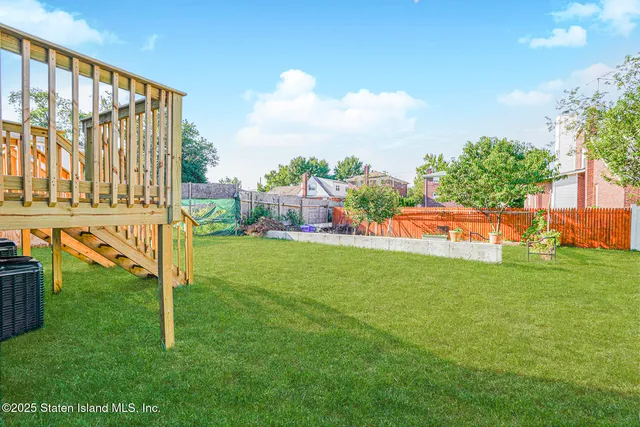 a view of yard with swimming pool and green space