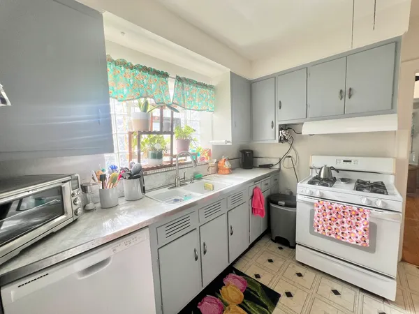 a kitchen with sink cabinets and window