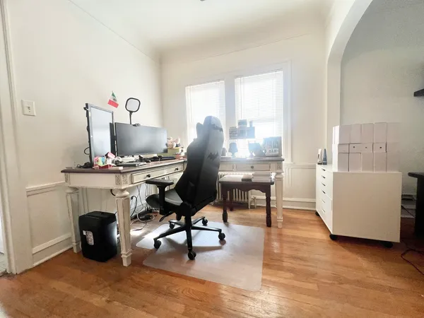 a view of a workspace with furniture and a window