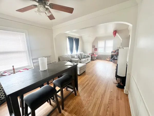 a view of a dining room with furniture window and wooden floor