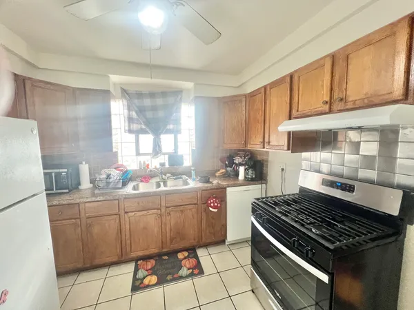 a kitchen with a stove a sink and a refrigerator