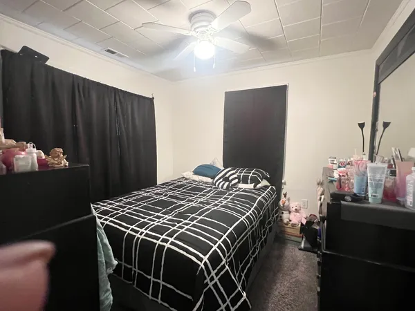 a bedroom with a bed and a dresser