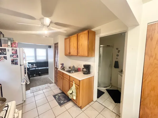 a kitchen with a stove a refrigerator and cabinets