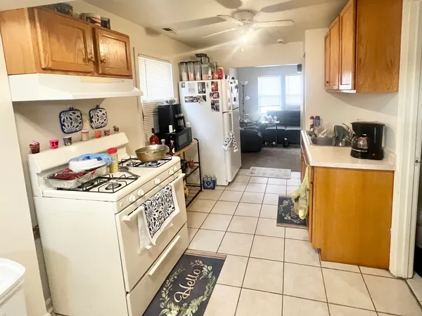 a kitchen with a stove a refrigerator and cabinets