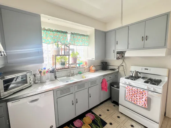 a kitchen with a sink stove and cabinets