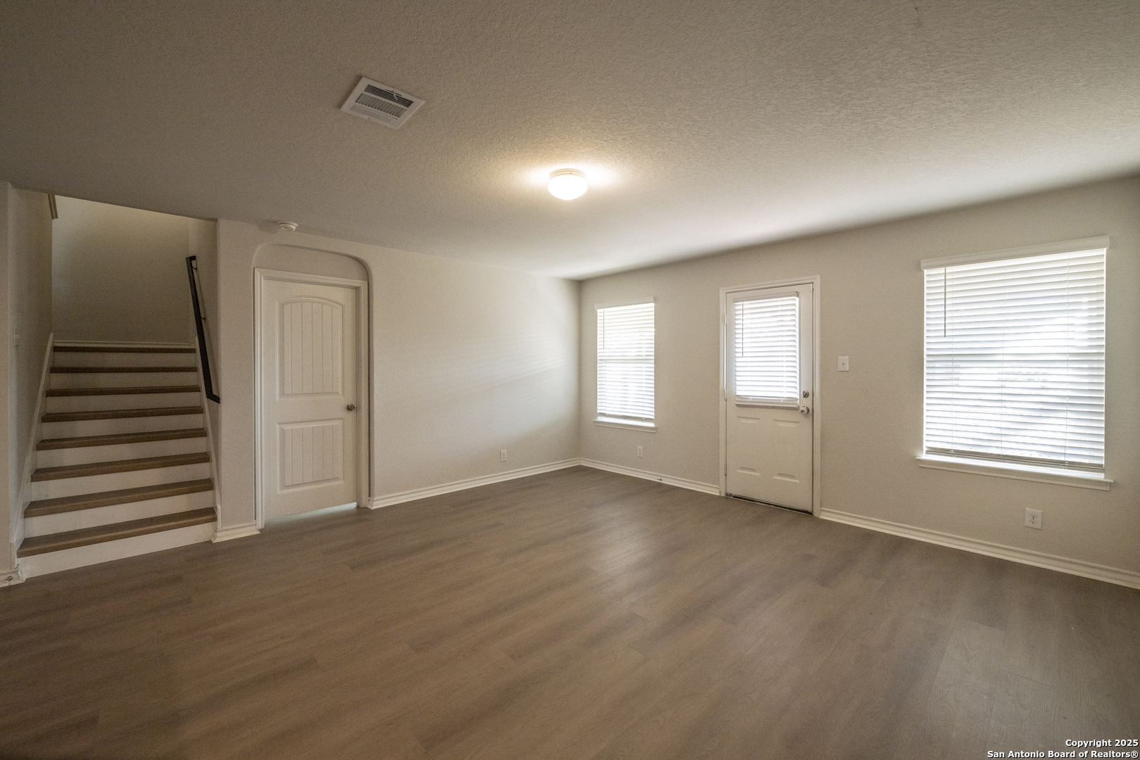 5914 Lazo Valley San Antonio, TX 78244 - Photo 12 of 40 a view of an empty room with wooden floor and a window