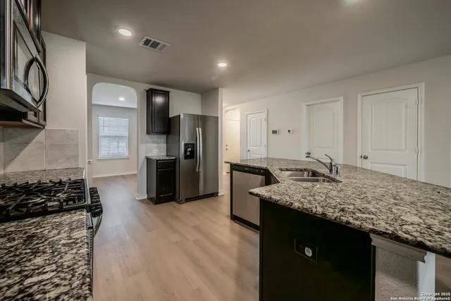 a kitchen with a sink stove and refrigerator