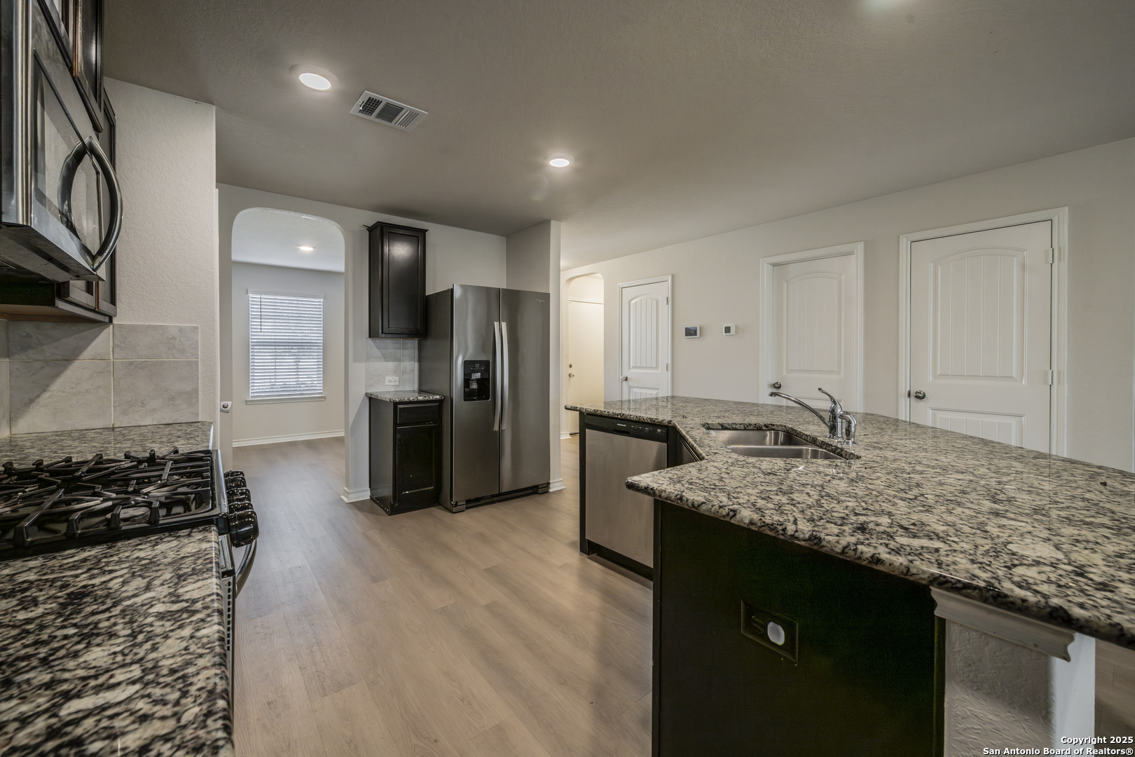 5914 Lazo Valley San Antonio, TX 78244 - Photo 15 of 40 a kitchen with a sink stove and refrigerator