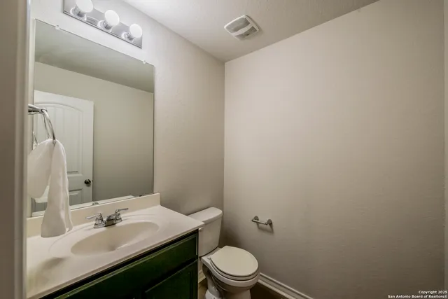 a bathroom with a sink toilet and mirror