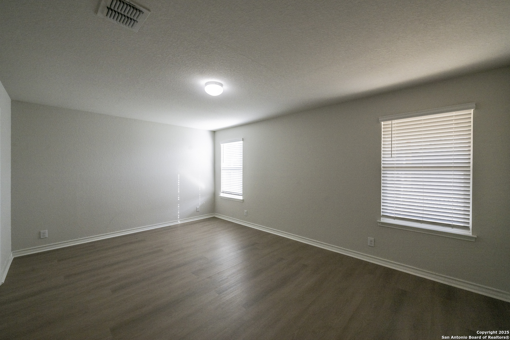 5914 Lazo Valley San Antonio, TX 78244 - Photo 18 of 40 an empty room with wooden floor and windows