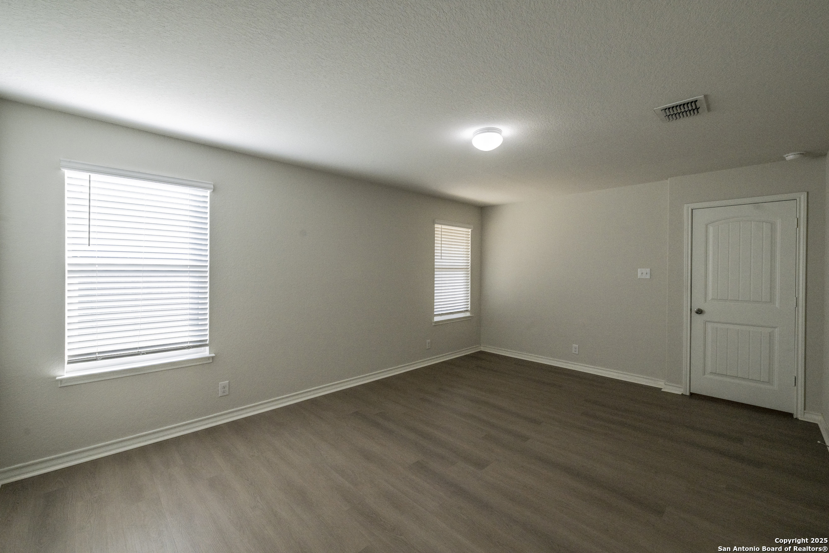 5914 Lazo Valley San Antonio, TX 78244 - Photo 19 of 40 an empty room with wooden floor and windows