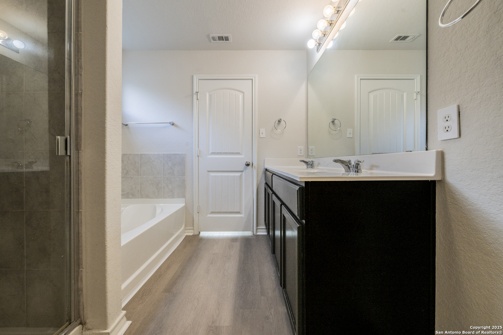 5914 Lazo Valley San Antonio, TX 78244 - Photo 22 of 40 a bathroom with a tub sink and mirror
