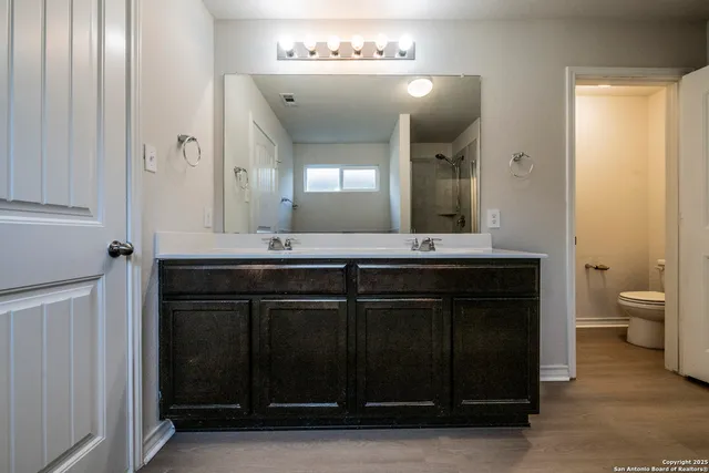 a bathroom with a sink vanity and a mirror