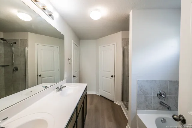 a bathroom with a tub sink and mirror