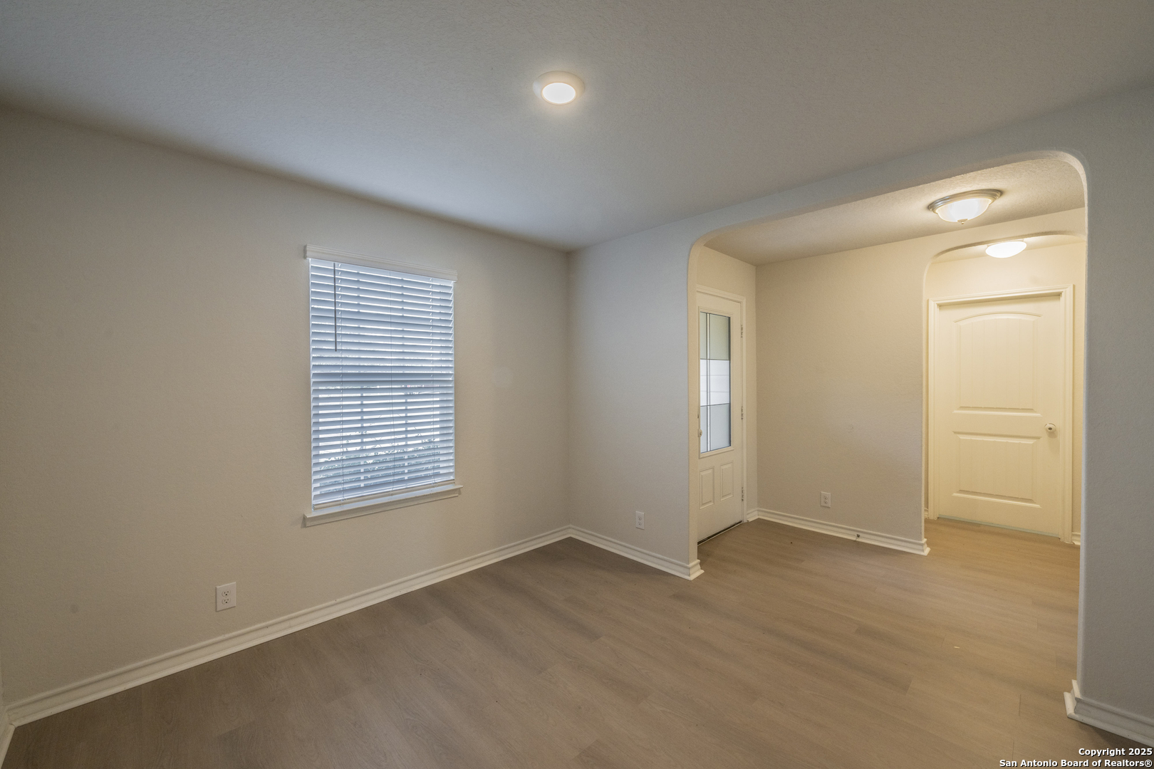 5914 Lazo Valley San Antonio, TX 78244 - Photo 4 of 40 an empty room with wooden floor and windows