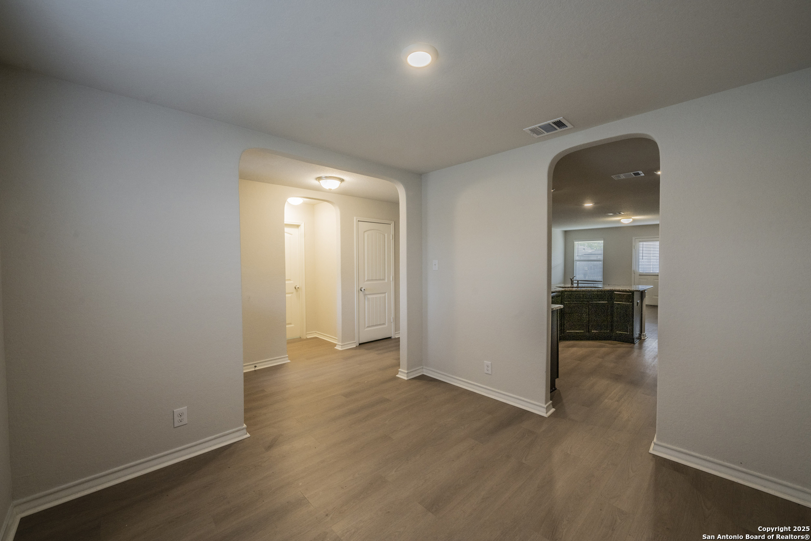 5914 Lazo Valley San Antonio, TX 78244 - Photo 5 of 40 an empty room with wooden floor and a bathroom