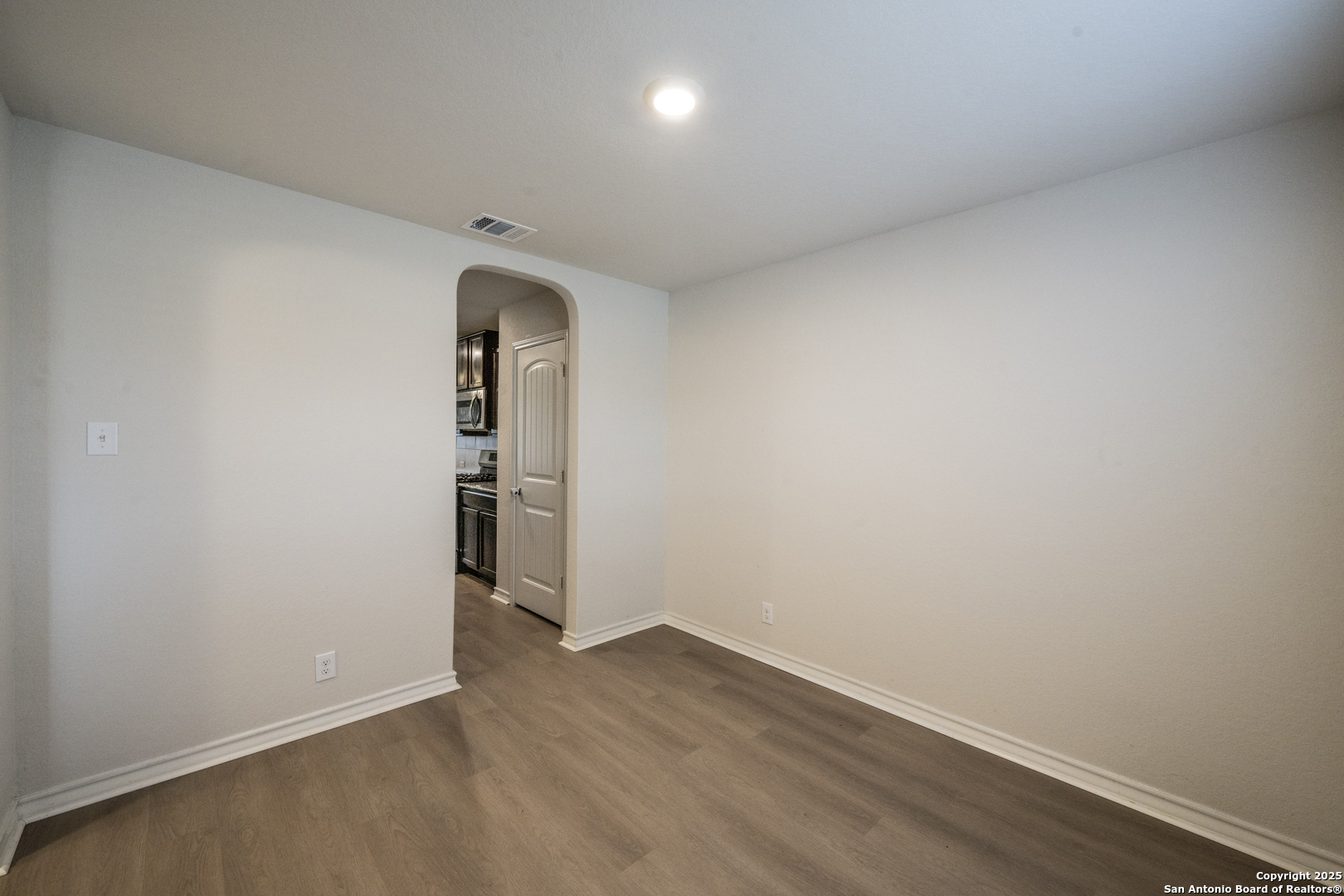 5914 Lazo Valley San Antonio, TX 78244 - Photo 6 of 40 an empty room with wooden floor and mirror