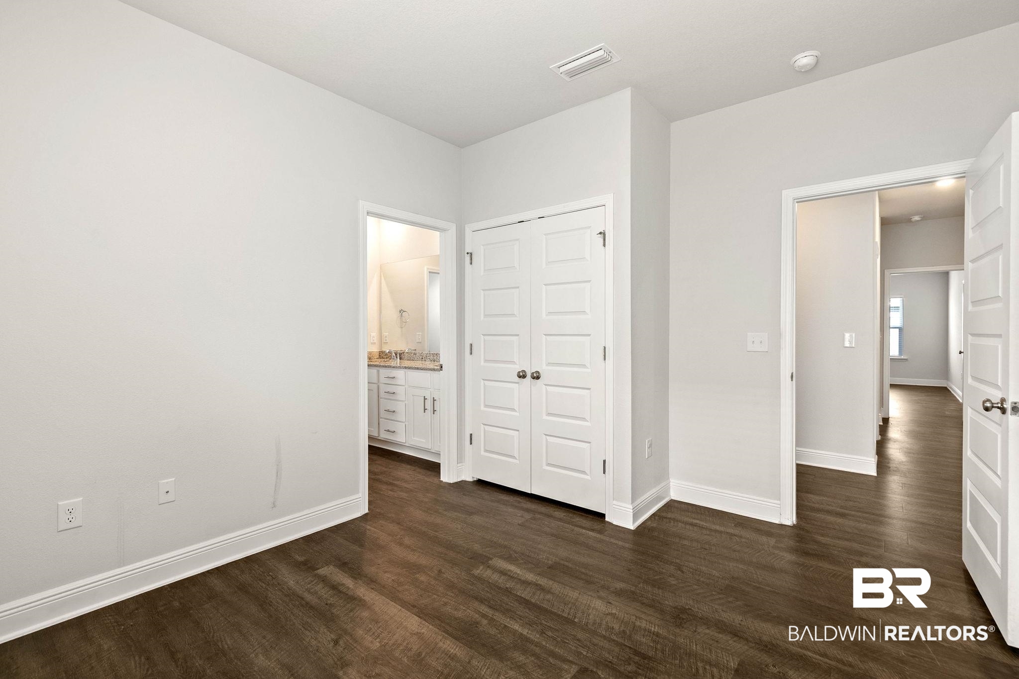 9448 Amethyst Drive Daphne, AL 36526 - Photo 35 of 61 Unfurnished bedroom featuring dark wood-style floors, ensuite bath, and a closet