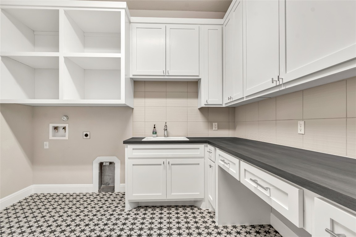 1700 Jackpot Run Leander, TX 78641 - Photo 18 of 40 a kitchen with granite countertop white cabinets and sink