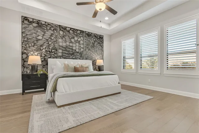 a bedroom with a bed and a chandelier