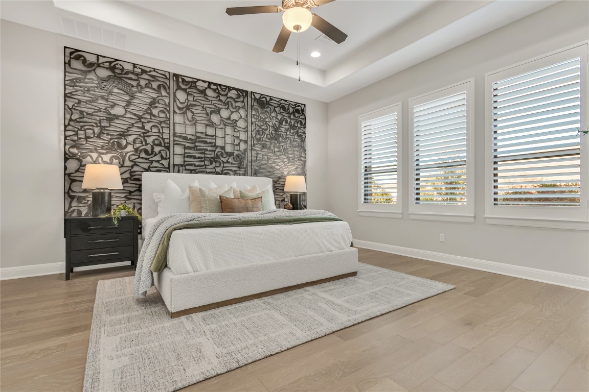 1700 Jackpot Run Leander, TX 78641 - Photo 19 of 40 a bedroom with a large bed and a chandelier fan